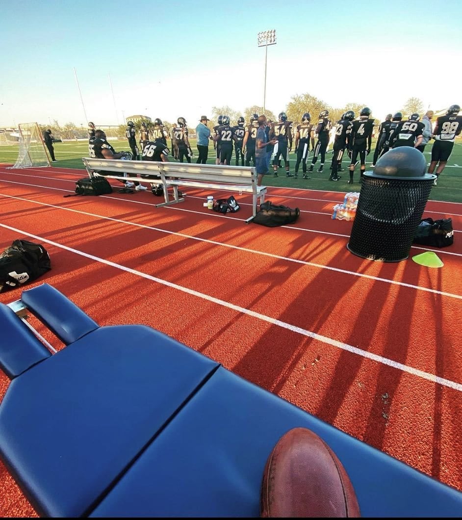 The practice's portable table set up beside a school track