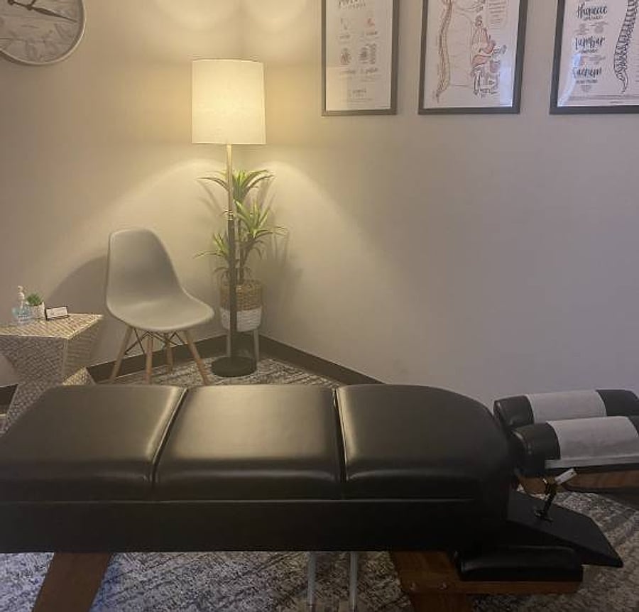A quiet corner of the clinic with a chair, lamp and treatment table