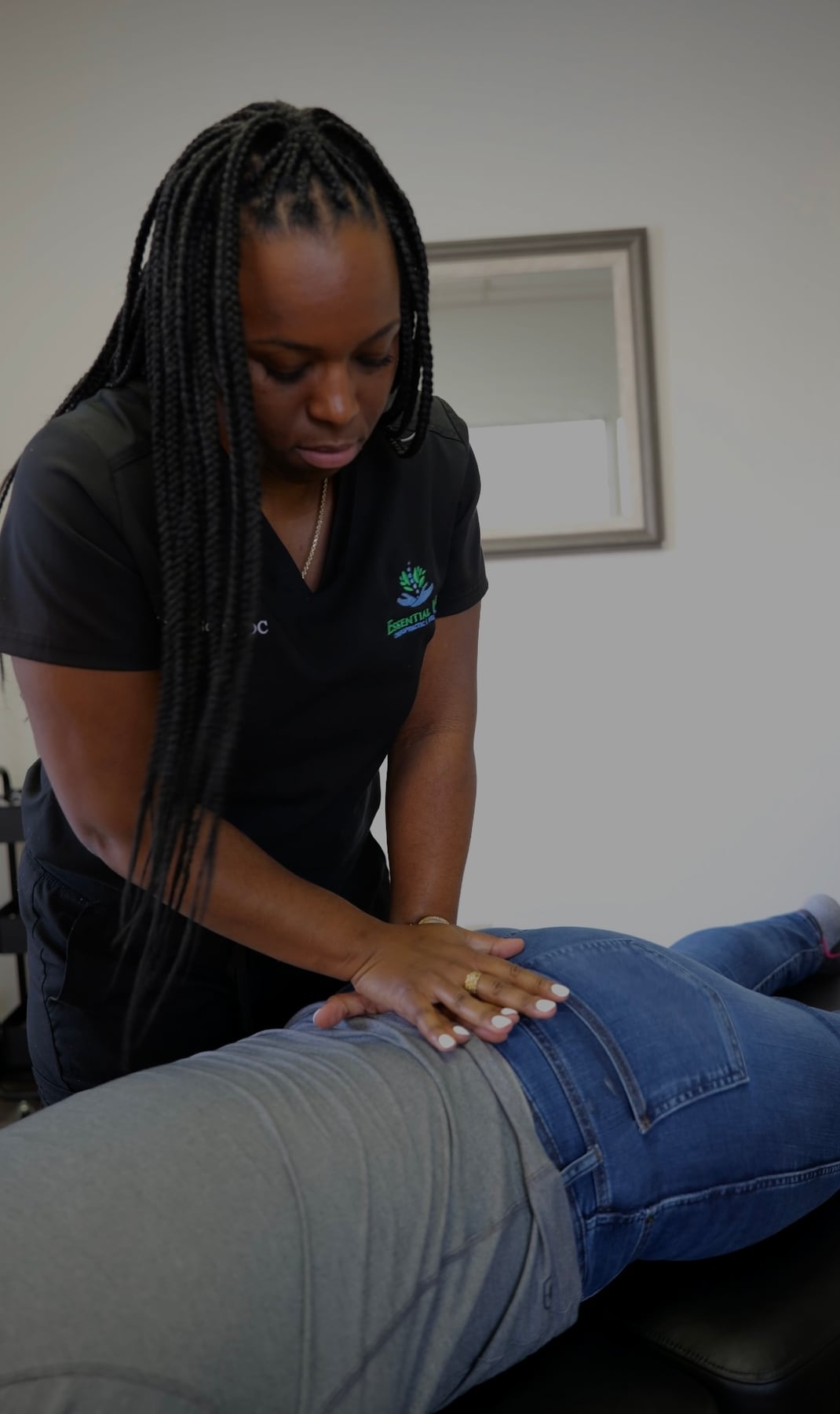 Dr. Janay Scott, D.C., adjusting a patient's lower back