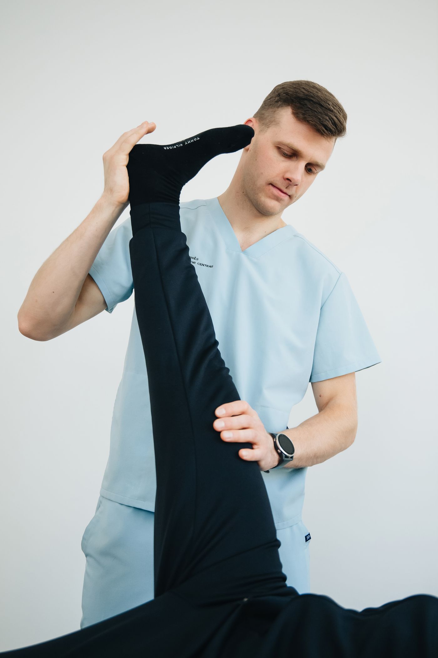A practitioner assisting a patient with a supported stretch