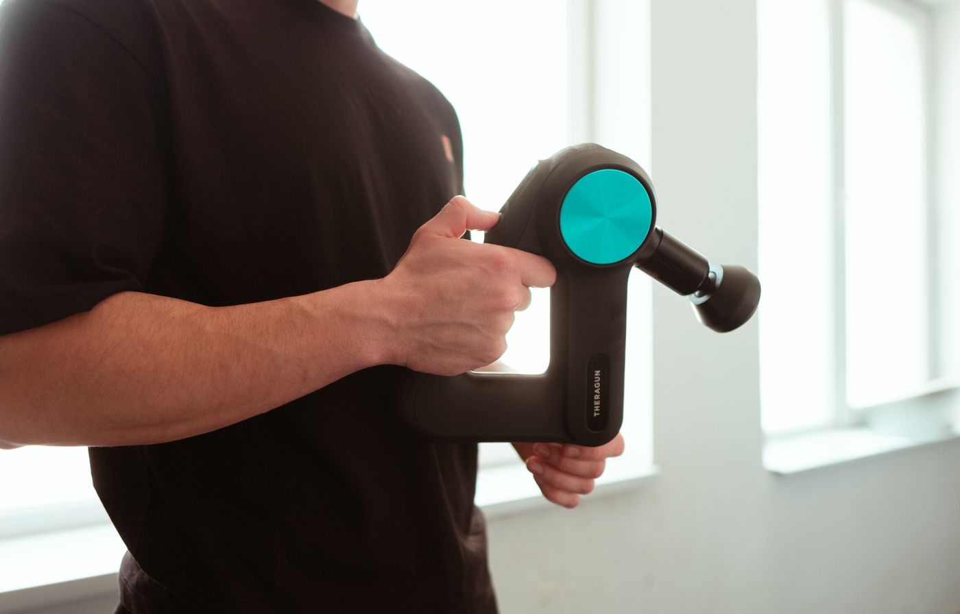 A percussion device being used for soft-tissue work