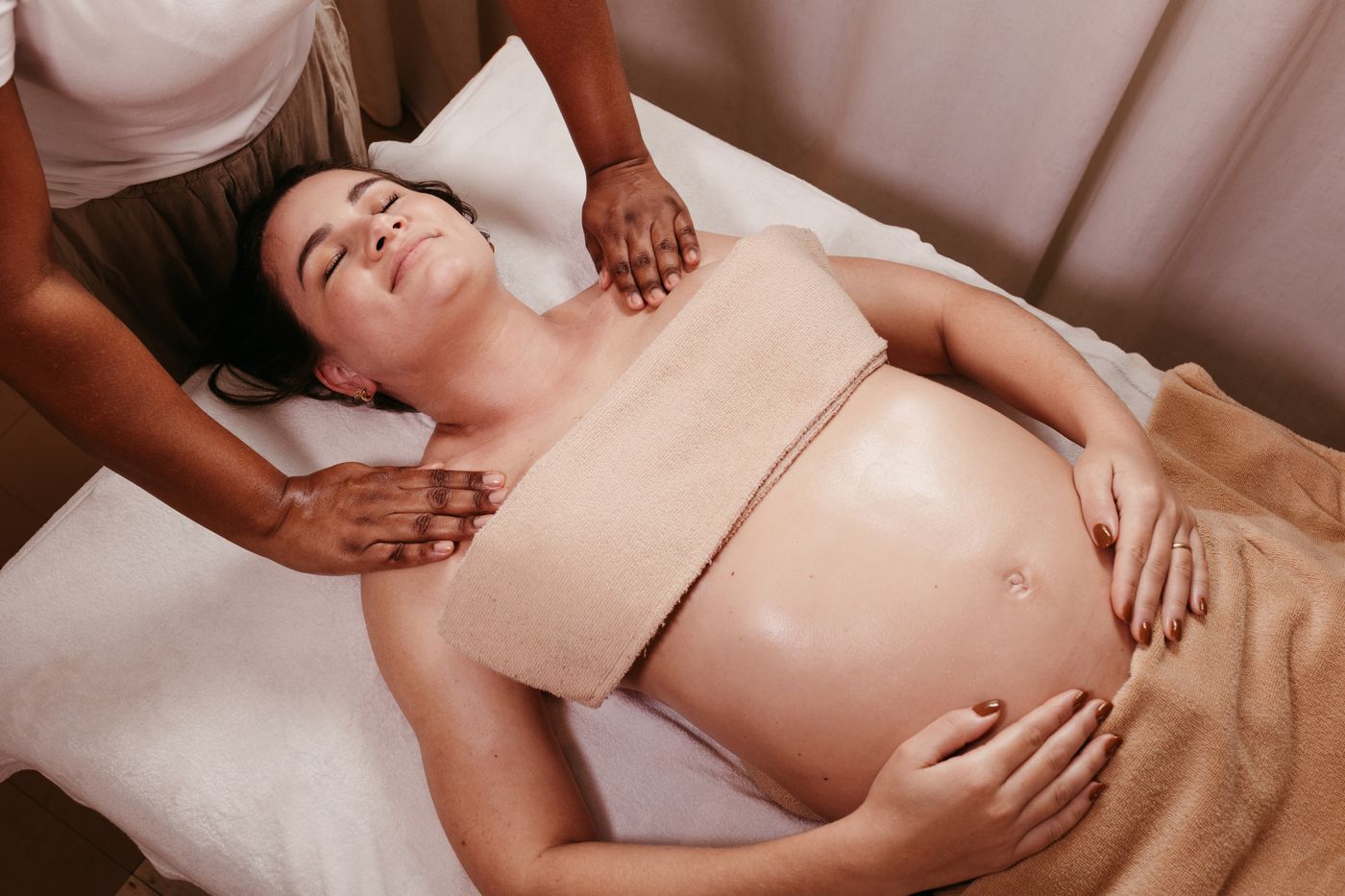 A pregnant person receiving gentle hands-on care