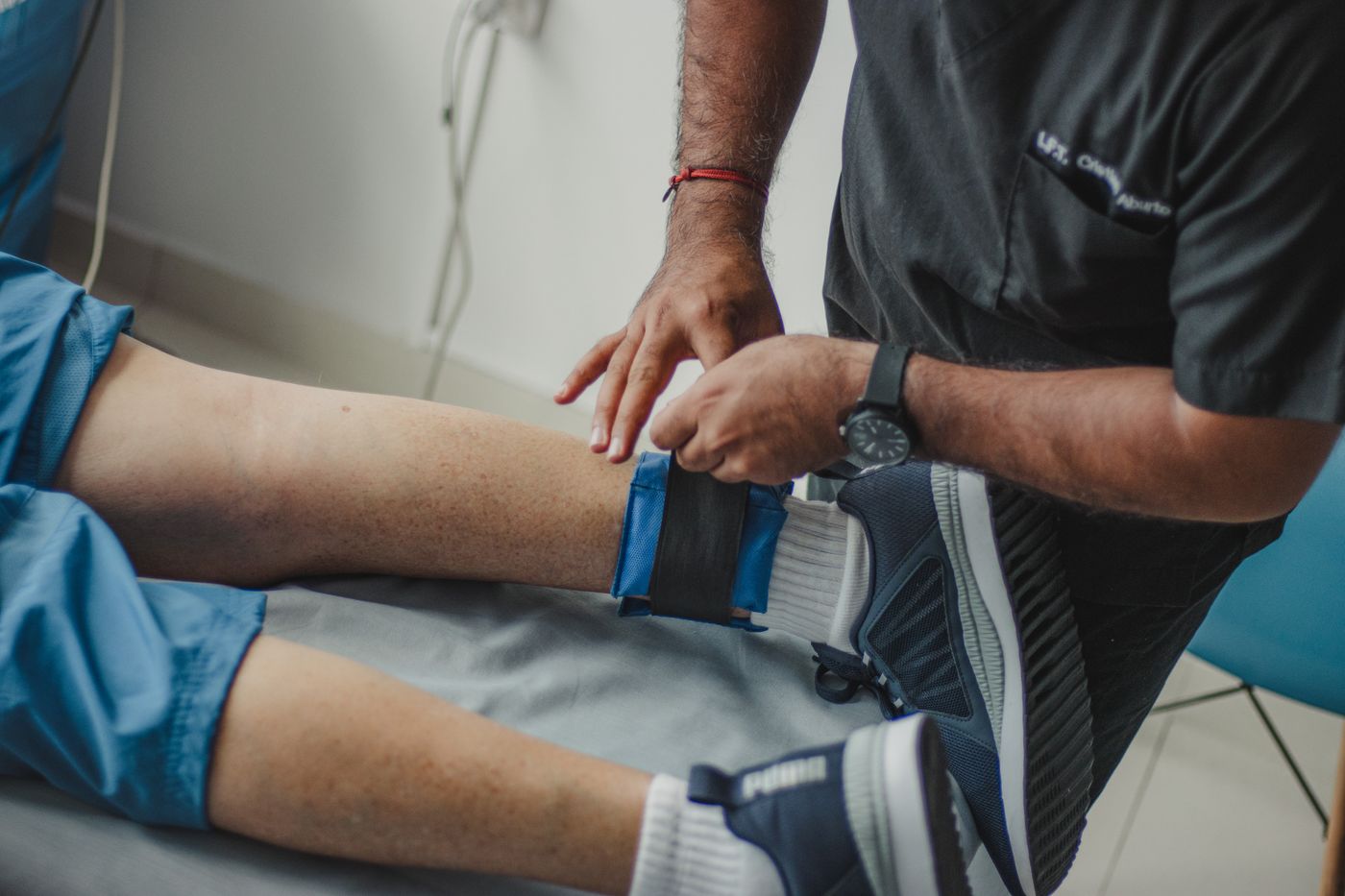 A practitioner assessing a patient's movement during rehab